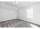 Bedroom with gray carpet, white walls and a window at 1517 Ellie Ridge Ave, Lawrenceville, GA 30043