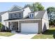Attractive two-story brick home featuring a covered porch and attached two-car garage at 1517 Ellie Ridge Ave, Lawrenceville, GA 30043