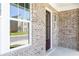 Beautiful front entrance with a dark wood door, modern windows and a grey brick exterior at 1517 Ellie Ridge Ave, Lawrenceville, GA 30043