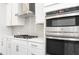 Modern kitchen featuring stainless steel appliances and gray backsplash at 1517 Ellie Ridge Ave, Lawrenceville, GA 30043