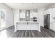 Kitchen island with stainless dishwasher, modern sink, and pendant lighting above at 1517 Ellie Ridge Ave, Lawrenceville, GA 30043