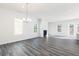 Open-concept living room with ample natural light, a fireplace, and modern gray floors at 1517 Ellie Ridge Ave, Lawrenceville, GA 30043
