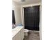 Well-lit bathroom featuring a vanity, toilet, and a bathtub with a black patterned shower curtain at 536 Magnolia Cir # 116, Palmetto, GA 30268