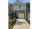 Charming townhome exterior with a well-manicured lawn and attached one car garage and brick and siding details at 536 Magnolia Cir # 116, Palmetto, GA 30268
