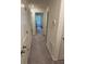 Hallway featuring neutral carpet with white doors at 536 Magnolia Cir # 116, Palmetto, GA 30268
