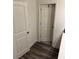 Hallway featuring hardwood floors and white doors at 536 Magnolia Cir # 116, Palmetto, GA 30268