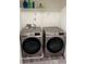 Modern laundry room with gray washer and dryer and white shelving at 536 Magnolia Cir # 116, Palmetto, GA 30268