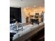 Inviting living room and kitchen open-concept space with a couch, island seating and stainless appliances at 536 Magnolia Cir # 116, Palmetto, GA 30268