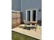 Cozy patio with a small table and chairs, enclosed by a wooden fence, ideal for outdoor relaxation at 536 Magnolia Cir # 116, Palmetto, GA 30268