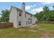 Well-maintained backyard with a view of the home's back exterior and a wooden fence at 6341 Stewart Ridge Walk, Buford, GA 30518