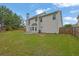 Spacious backyard with a view of the home's rear facade, featuring a patio and well-maintained lawn at 6341 Stewart Ridge Walk, Buford, GA 30518