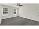 Bedroom with neutral walls, carpet flooring, ceiling fan, and double windows at 6341 Stewart Ridge Walk, Buford, GA 30518