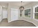 Inviting dining area with a modern chandelier, multiple windows, and closet space at 6341 Stewart Ridge Walk, Buford, GA 30518