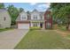 Charming two-story home with a brick and siding exterior, a well-manicured lawn, and an attached two-car garage at 6341 Stewart Ridge Walk, Buford, GA 30518