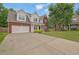 Inviting two-story home featuring a brick and siding facade, attached two-car garage, and a spacious driveway at 6341 Stewart Ridge Walk, Buford, GA 30518