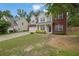Lovely two-story home with a brick and siding exterior, complemented by a well-maintained lawn and attached garage at 6341 Stewart Ridge Walk, Buford, GA 30518
