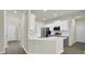 Modern kitchen with white cabinets, stainless steel appliances, and a breakfast bar at 6341 Stewart Ridge Walk, Buford, GA 30518