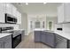 Beautiful kitchen features stainless appliances, white cabinets, and a breakfast bar island at 6341 Stewart Ridge Walk, Buford, GA 30518