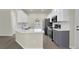 Well-equipped kitchen features stainless steel appliances, white cabinets, and a breakfast bar at 6341 Stewart Ridge Walk, Buford, GA 30518
