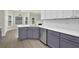Modern kitchen with stainless steel appliances, white countertops and gray cabinets at 6341 Stewart Ridge Walk, Buford, GA 30518