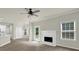 Open living space boasts a fireplace, ceiling fan, and flows into the dining area at 6341 Stewart Ridge Walk, Buford, GA 30518