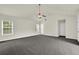 A large living room with carpet, neutral paint, ceiling fan, and large windows at 6341 Stewart Ridge Walk, Buford, GA 30518