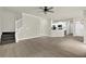 Open-concept living area showcasing hardwood floors, staircase, and access to the kitchen at 6341 Stewart Ridge Walk, Buford, GA 30518