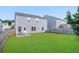 Spacious backyard with a well-maintained lawn, privacy fence, and patio area at 105 Paulowina Cir, Mcdonough, GA 30253