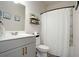 Stylish bathroom featuring a gray vanity, new fixtures and a shower with decorative curtain at 105 Paulowina Cir, Mcdonough, GA 30253