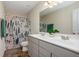 Bathroom with a double sink vanity, decorative shower curtain, and great lighting at 105 Paulowina Cir, Mcdonough, GA 30253