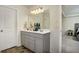 Modern bathroom featuring double sinks, a large mirror, and stylish fixtures at 105 Paulowina Cir, Mcdonough, GA 30253