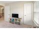 Cozy bedroom features a TV and shelves for organized storage and decor at 105 Paulowina Cir, Mcdonough, GA 30253