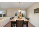 Cozy dining room with a large table, leather chairs, and natural lighting at 105 Paulowina Cir, Mcdonough, GA 30253