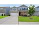 Charming two-story home with a brick facade, attached garage, and manicured lawn at 105 Paulowina Cir, Mcdonough, GA 30253