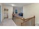 Upstairs hallway with laundry room and view of a living room with blue sofa at 105 Paulowina Cir, Mcdonough, GA 30253