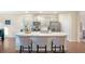 Stylish kitchen island featuring seating, a sink, and a view into the adjacent spaces at 105 Paulowina Cir, Mcdonough, GA 30253