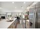 Open concept kitchen with stainless steel appliances, a view into the living and dining area at 105 Paulowina Cir, Mcdonough, GA 30253