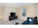 Cozy living room with a modern TV and a comfortable dark sofa at 105 Paulowina Cir, Mcdonough, GA 30253