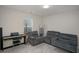 Bright living room featuring comfortable seating, a keyboard, and ample natural light at 105 Paulowina Cir, Mcdonough, GA 30253