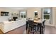 Comfortable living room with fireplace, dining area, and a view to the outdoor space at 105 Paulowina Cir, Mcdonough, GA 30253