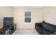 Inviting living room featuring a comfortable sofa and a large window for natural light at 105 Paulowina Cir, Mcdonough, GA 30253
