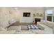Inviting living room featuring a fireplace, plush white sofa, and a large TV at 105 Paulowina Cir, Mcdonough, GA 30253