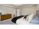 Spacious main bedroom with ample storage, a comfortable bed, and tray ceiling at 105 Paulowina Cir, Mcdonough, GA 30253