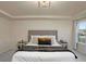 Bright main bedroom featuring a tray ceiling, large bed, and natural light from windows at 105 Paulowina Cir, Mcdonough, GA 30253