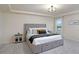 Serene main bedroom with a plush bed, modern lighting, and tray ceiling at 105 Paulowina Cir, Mcdonough, GA 30253