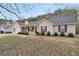 Charming single story home featuring manicured shrubs, neutral siding and a covered front porch at 130 Nicki Ct, Hampton, GA 30228