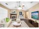 Bright living room boasts hardwood floors, neutral colors, a ceiling fan and fireplace at 130 Nicki Ct, Hampton, GA 30228