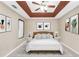 Stylish main bedroom with tray ceiling, fan, and decorative wall art at 130 Nicki Ct, Hampton, GA 30228