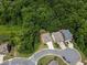 Expansive aerial view of a neighborhood featuring beautiful landscaping and well-maintained lawns surrounded by lush greenery at 204 Starwood Ct, Acworth, GA 30102