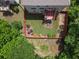Private backyard featuring a deck, patio furniture, landscaped garden beds and a fenced perimeter for added seclusion at 204 Starwood Ct, Acworth, GA 30102